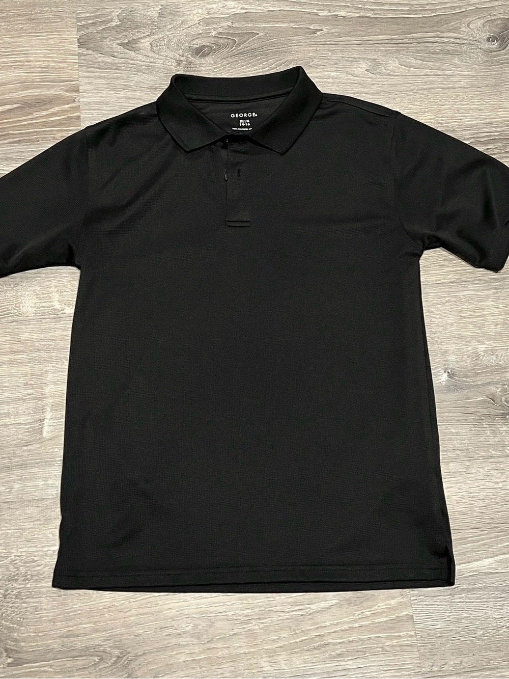 Boys black George performance polo shirt featuring a three-button placket XL